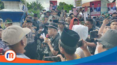 Rofi, orator aksi (Memakai topi hitam dengan microfon merah ditangannya) saat menuntut Pilkades segera digelar
