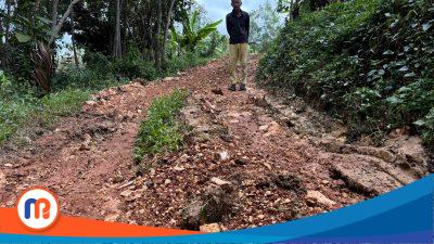 Warga setempat saat melewati jalan makadam yang diduga asal jadi di Duaun Toguran, Desa Tlagah, Kecamatan Banyuates, Kabupaten Sampang